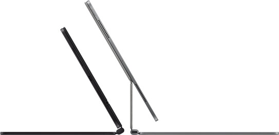Two Magic Keyboards with iPad Pro attached shown back to back in Space Black and Silver finishes